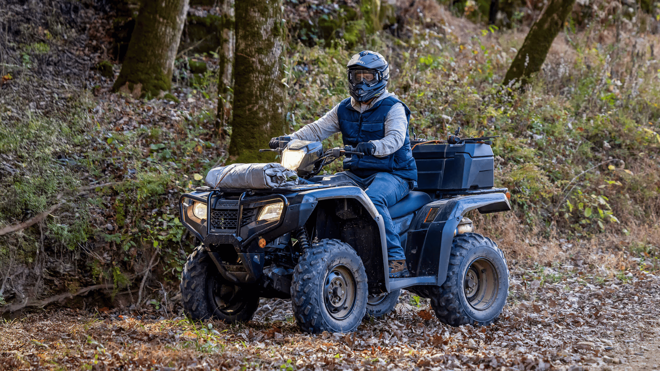 Handlebar and LCD display of 2025 Honda FourTrax Foreman 4x4 ATV with warning labels and rugged matte finish