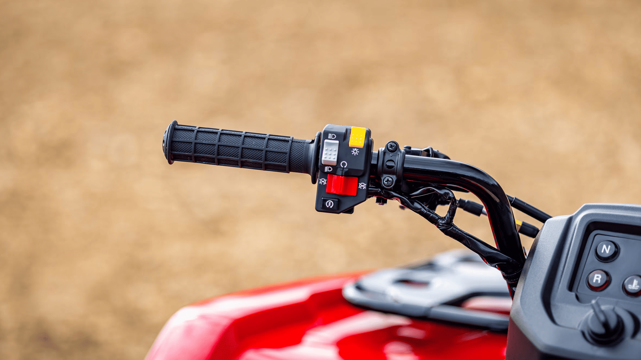 Handlebar close-up of Honda FourTrax Rancher 4x4, black grips and control switches