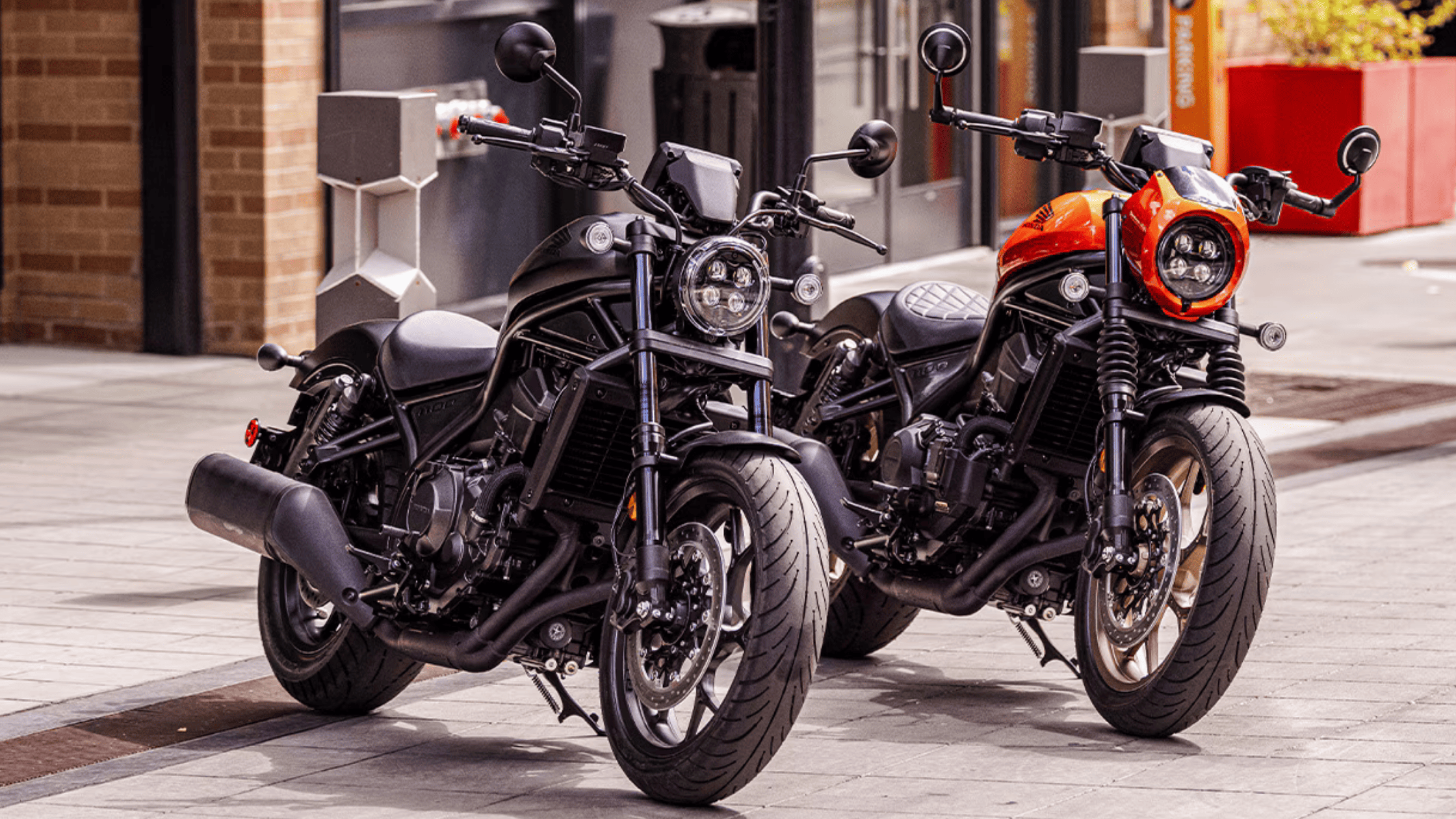 Side profile of rider on matte black 2025 Honda Rebel 1100 DCT SE in motion, showcasing engine and exhaust detail