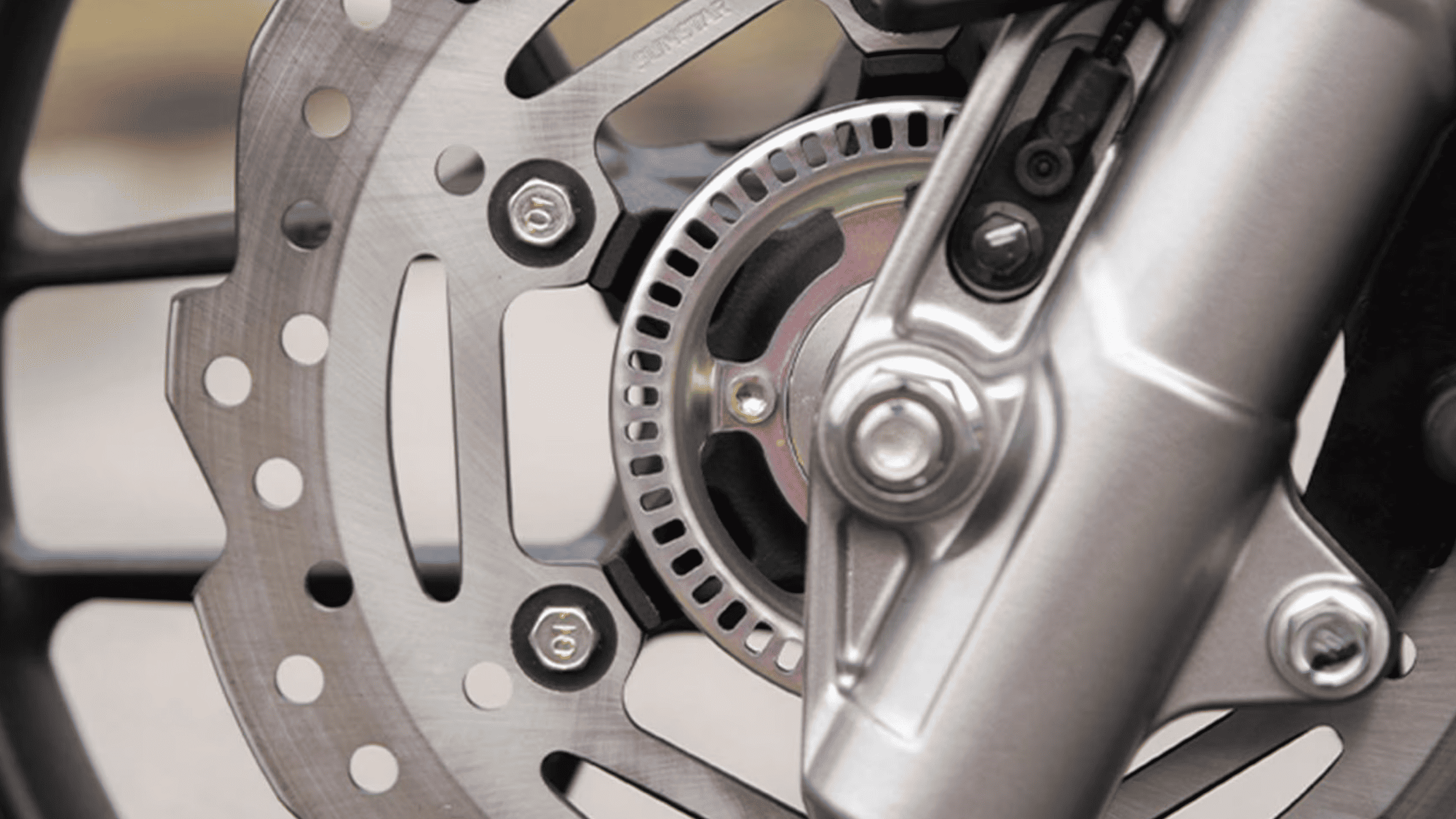 Three-quarter front view of the 2026 Honda ADV160 adventure scooter in silver, featuring angular headlights and tall windscreen.