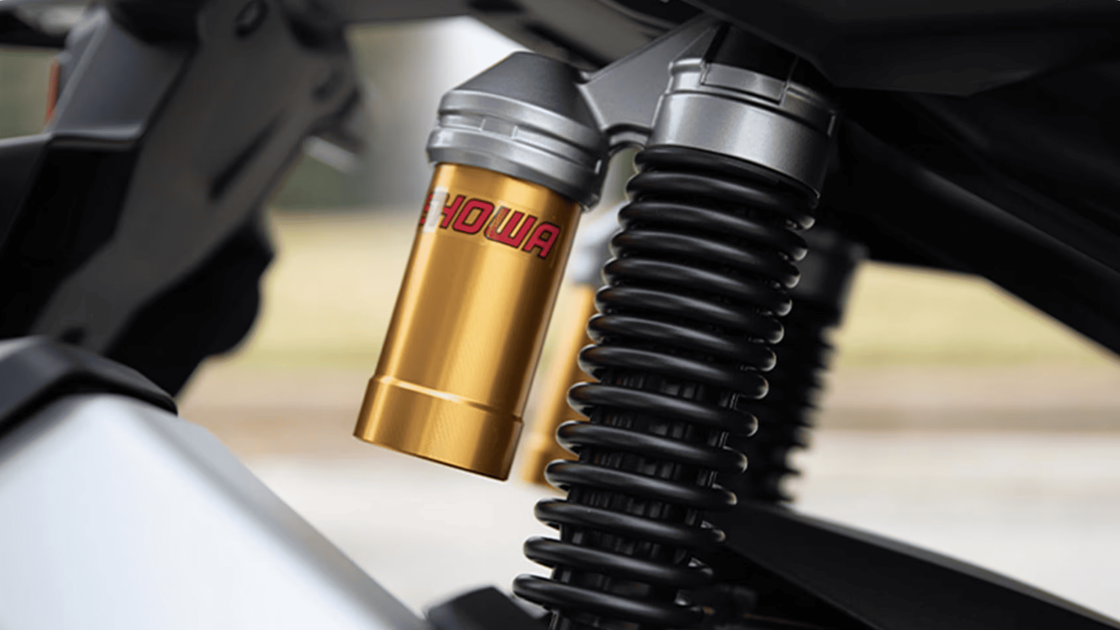 Close-up of the 2026 Honda ADV160 rear Showa suspension with gold reservoir for enhanced ride stability.